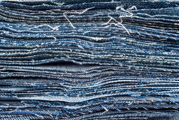 Texture from torn pieces of denim. Jeans texture. Material for sewing clothes