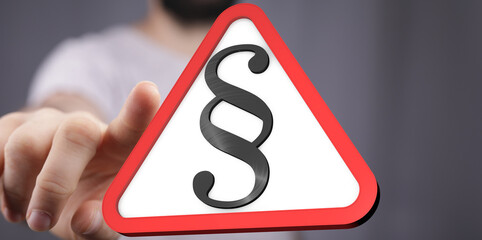 Image of a hand presenting a triangular warning sign with a paragraph symbol.  Perfect for legal, law, and compliance concepts.