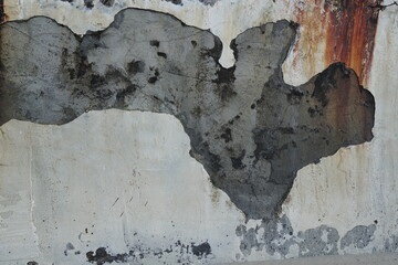 Abstract Concrete Wall Texture with Gray and Black Patches Against a Weathered Background