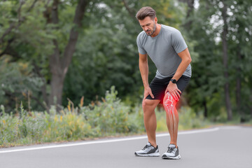 Athletic man is experiencing knee pain while exercising outdoors, demonstrating the impact of sports injuries on physical activity and health awareness