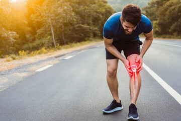 Athletic man is experiencing knee pain while exercising outdoors, demonstrating the impact of sports injuries on physical activity and health awareness