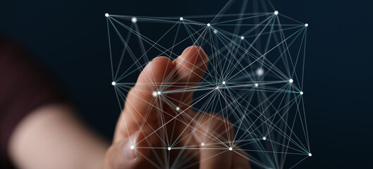 Abstract image of a hand interacting with a complex digital network, representing connection and...