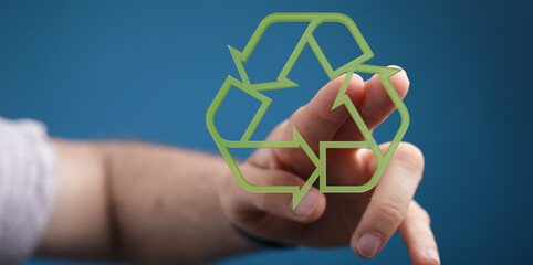 Eco-friendly concept.  Person's hand and a digital recycling symbol.