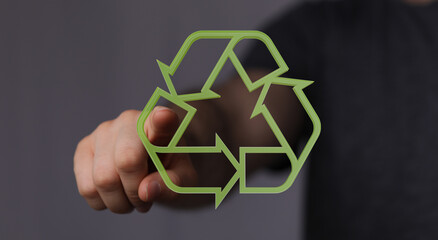 Hand gestures towards a digital recycle symbol.  Eco-friendly concept.