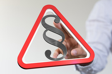 Stock photo of a hand interacting with a 3D red triangle warning sign featuring a paragraph symbol,...
