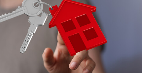 Hand holding house keys, symbolizing homeownership, new home, real estate, and property investment.