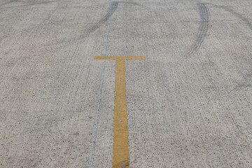Tire marks create patterns on empty parking lot surface