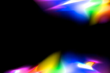 Colorful abstract glowing rainbow color light at border on black background with copy space in the middle