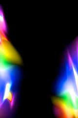 Colorful abstract glowing rainbow color light at border on black background with copy space in the middle