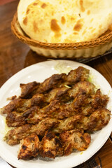 Delicious grilled Beef (Yak) skewers served with bread.