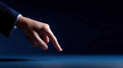 Businessman’s Hand Pointing on Dark Blue Background – Close-up Minimal Touch Gesture