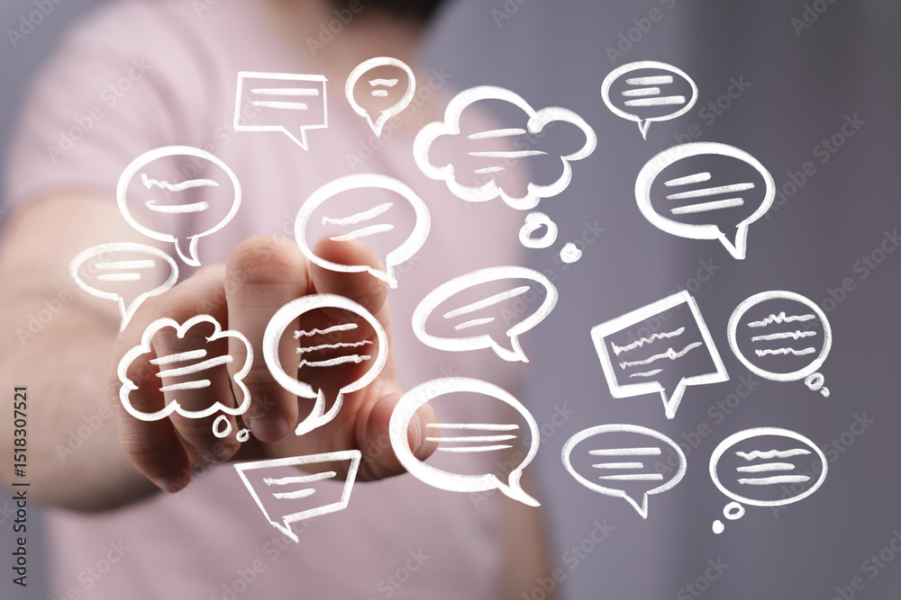 Fototapete hand interacting with floating speech bubbles, representing communication and online conversation.
