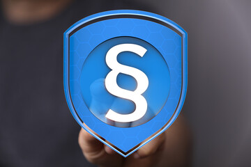 Secure your legal rights.  This image depicts a digital shield with a paragraph symbol,...