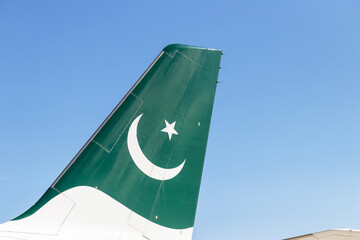 Tail of Pakistani airplane against blue sky