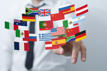 Image of a businessman interacting with flags representing global reach and international business.