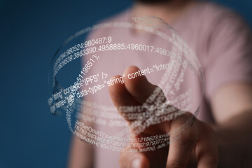 Close-up of a hand interacting with a transparent digital display showing lines of code.