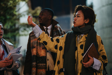 Group of multiracial colleagues engage in an animated discussion outdoors, showcasing teamwork, leadership, and collaboration in a professional environment, fostering brainstorming and decision-making