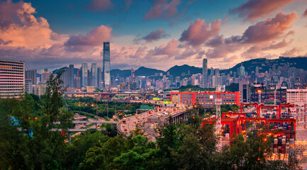Hong Kong city on dramatic sky at sunset view from mountain.