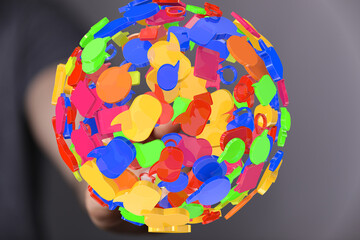 Abstract 3D rendering of colorful speech bubbles forming a sphere, representing global...