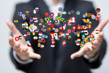 Image of hands holding various world flags, symbolizing global reach, international business, and worldwide connections.