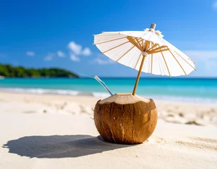 Gardinen Coconut on sand with a straw and umbrella, tropical sea in the background. © Марина Каліш