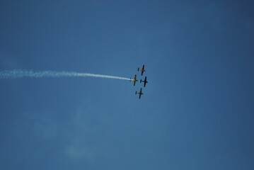 Aerial Display of Colorful Aircraft Formations in a Clear Blue Sky