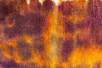 brown rusted sheet metal surface with white spray paint remnants
