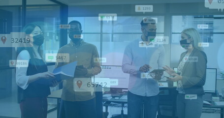 Image of data processing over diverse business people talking with face masks in office