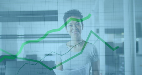 Image of data processing over african american businesswoman smiling in office