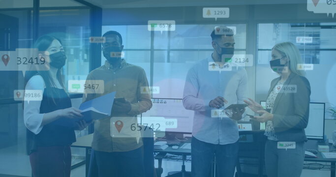 Image of data processing over diverse business people talking with face masks in office