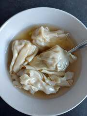 Chinese won-ton soup with fork