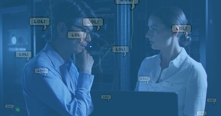 Image of lol texts falling over diverse couple of server room workers