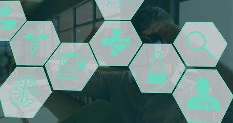 Image of medical icons over men using vr headset