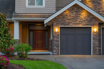 Garage door in luxury house with trees and nice landscape in Spring in Vancouver, Canada, North...