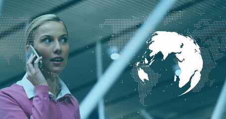 Image of world map over caucasian businesswoman at airport