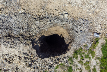 Aerial view of the place where the ground collapsed, forming holes due to the erosion of the ceiling of the salt mine in Praid - Romania