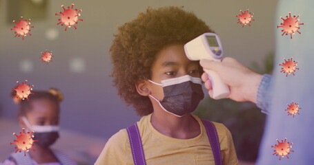 Image of virus cells over caucasian woman checking temperature to pupils in face masks