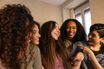 A group of multiethnic friends sharing a laugh indoors