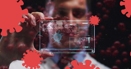 Image of coronavirus cells over male doctor holding clear tablet processing data about cell