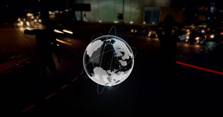 Image of globe and footballer silhouettes over fast speed traffic on city road at night