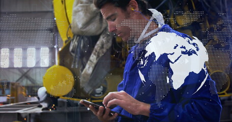 Image of world map over caucasian male worker using tablet