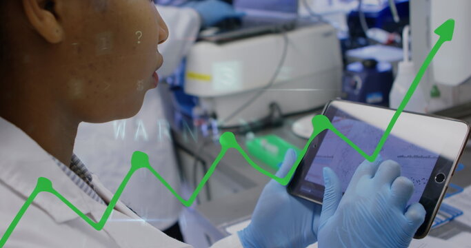 Image of financial graph over female worker using tablet