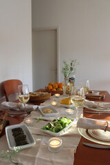 Festive holiday table with fresh flowers, citrus fruit basket, and natural light – elegant and seasonal Shavuot-inspired decor