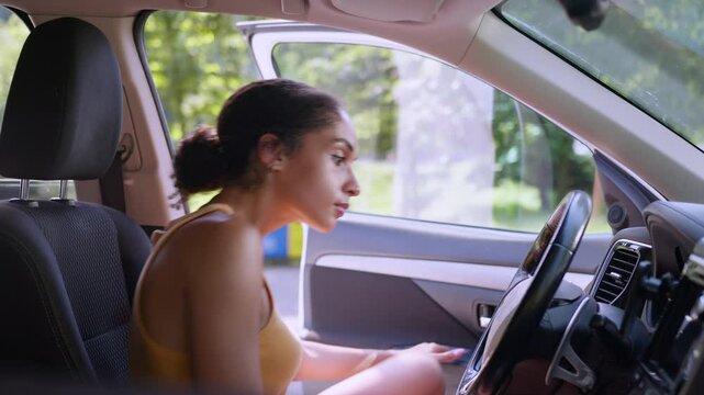Worried African American woman female girl trying start broken car auto automobile transport driver rental service problem electric battery charge steering crash businesswoman business owner vehicle