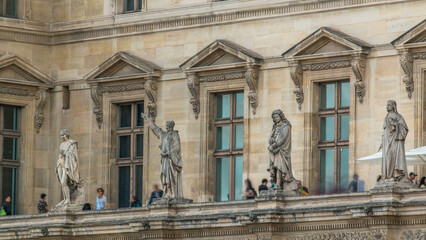 The facade of a building with male statues in the vicinity of the historic building timelapse, Paris, France.