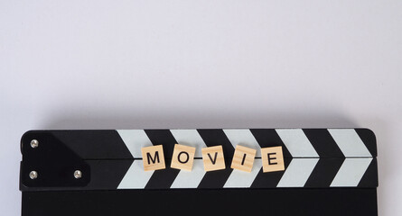 clapper board and scramble word movie on white background
