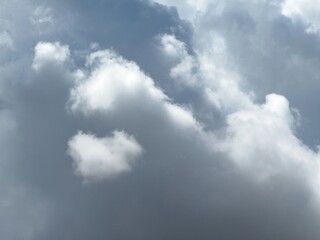 Obraz premium Fuffy clouds background. White and grey color cumulus cloudscape