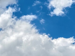 Blue sky with clouds, sunny day. White fluffy cloudscape, nature background