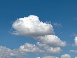 Obraz premium Blue sky with clouds background, sunny day. White and grey fluffy cloudscape