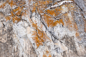 A rock with a white and orange color